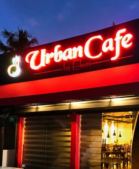 The UrbanCafe by Elees sign at night