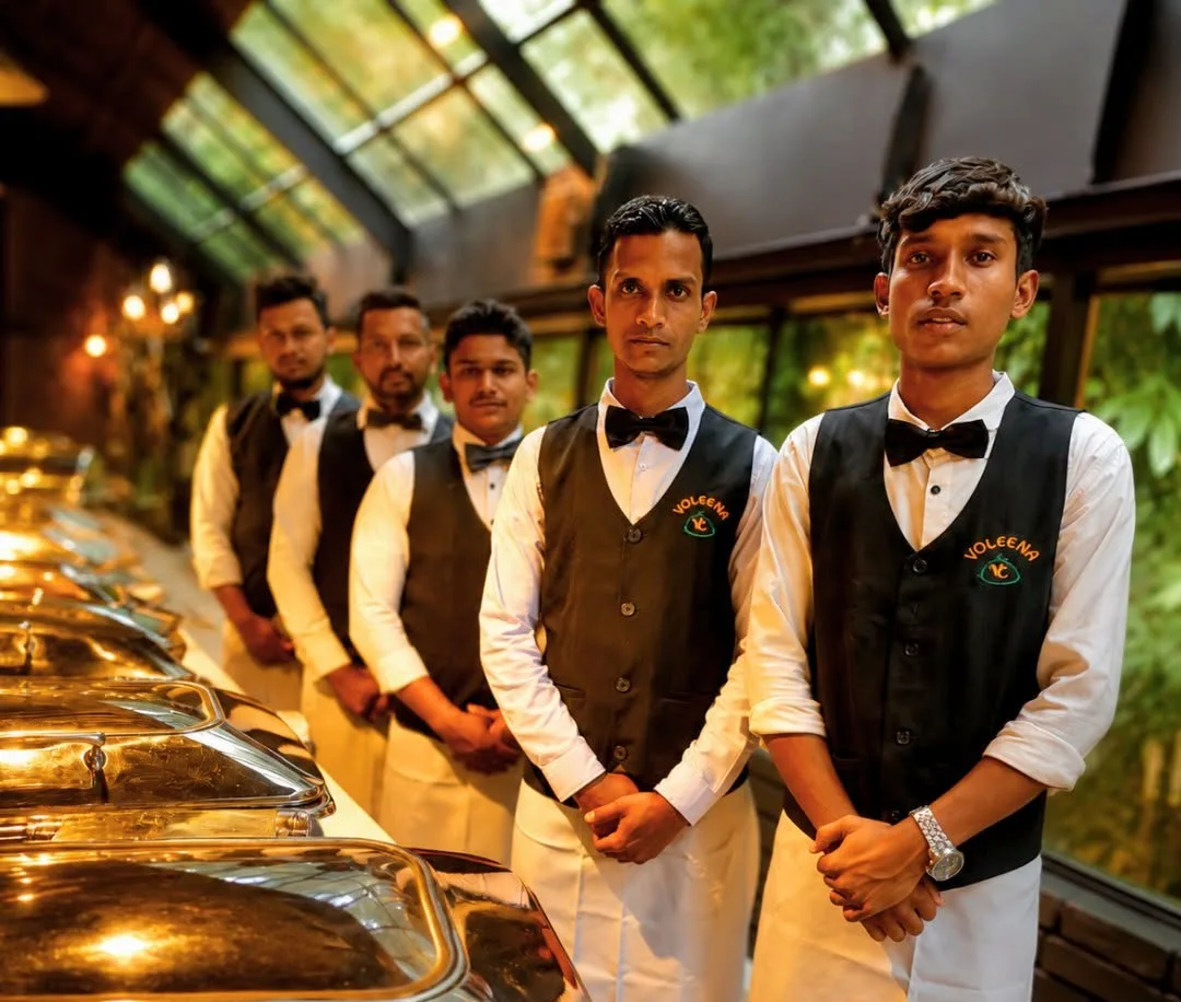 The Voleena Foods service team in uniform beside a buffet line